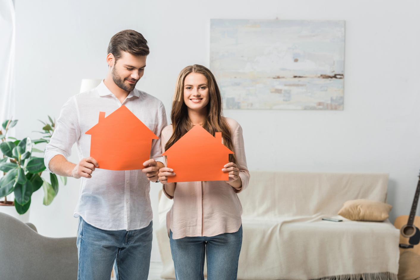 Couple Holding House Paper